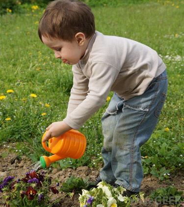 child-watering-the-garden